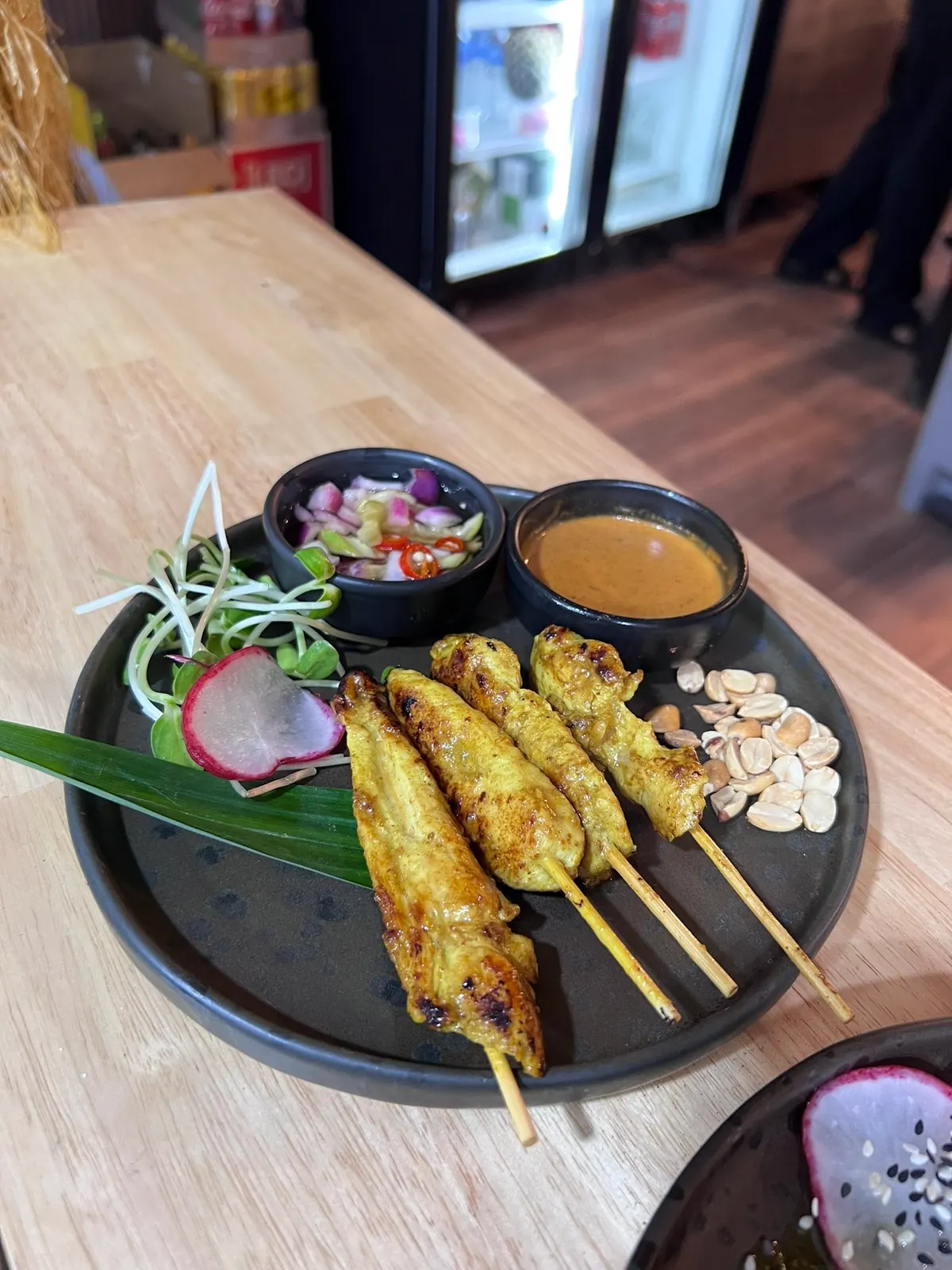 Grilled chicken satay skewers with peanut sauce and cucumber relish